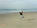 Jason playing frisbee on the beach
